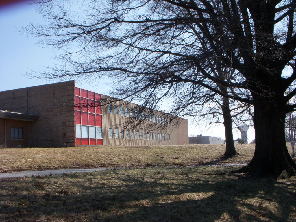 Attached to the headhouse is the factory building that extends along Industrial Drive. The red spandrel panels here echo those found in the interior courtyard..