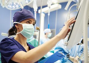 Nurse working with technology in operating room