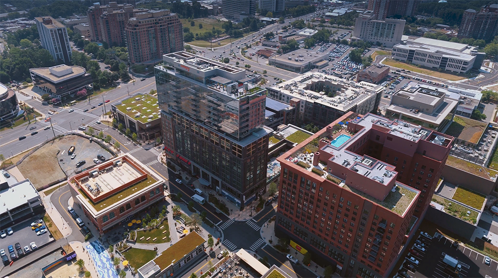 aerial photo of Montgomery County’s Pike and Rose development project. Shows the camera angle looking down on office, residential, hotel and green roofs with Wisconsin Avenue corridor to the left looking south. 