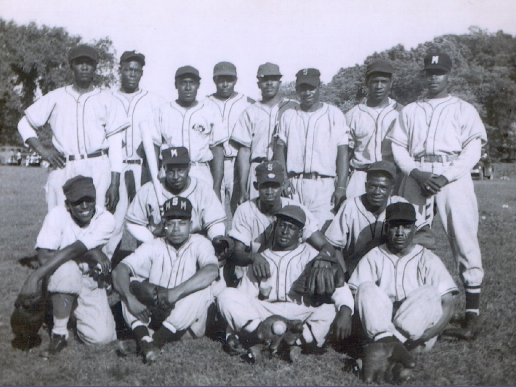 A black and white photo of an African American men’s baseball team. 