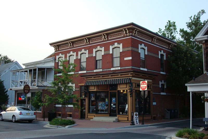 neighborhood main street area with a low-scale brick building with retail on the ground floor