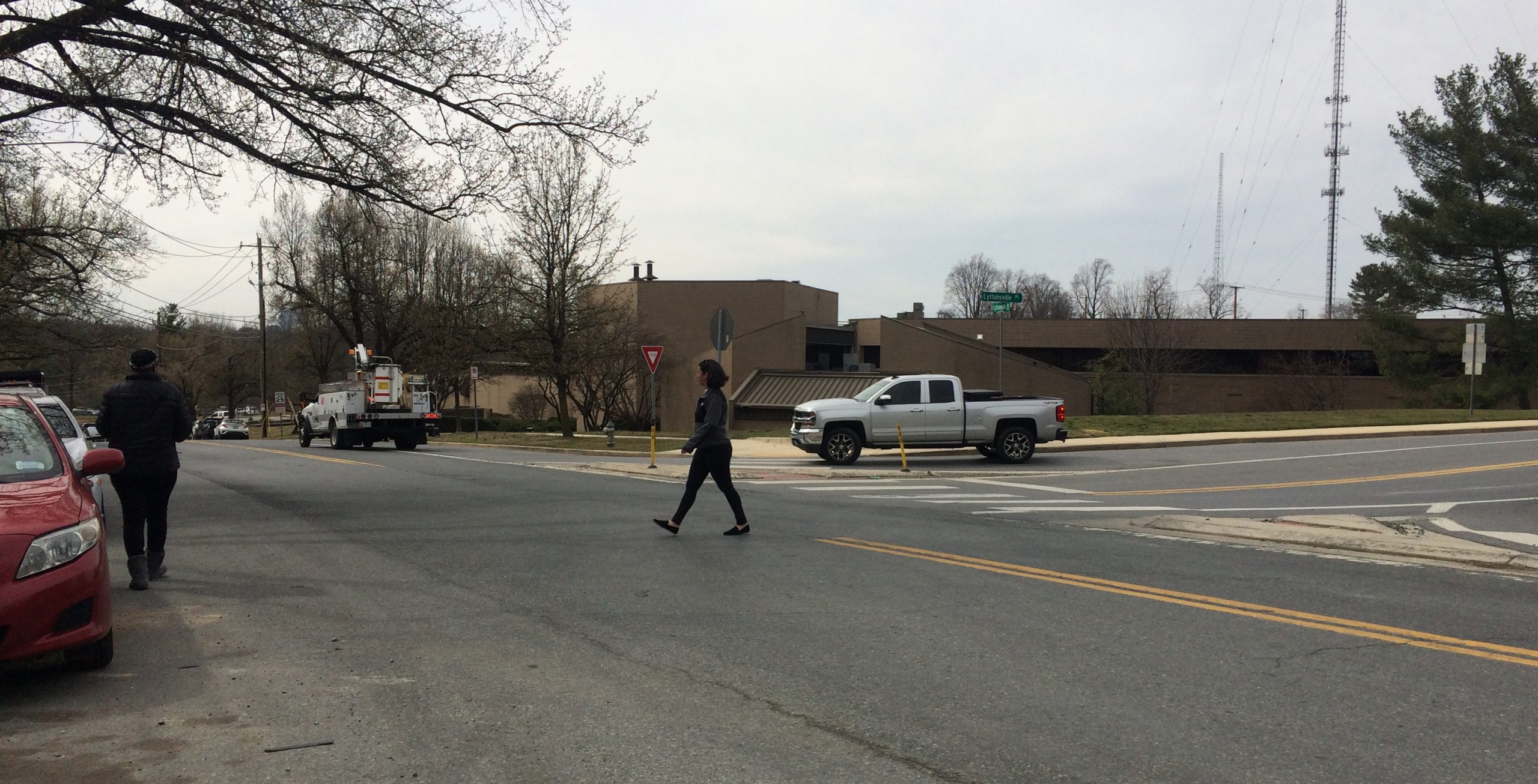 Woman crosses road with no marked crosswalk