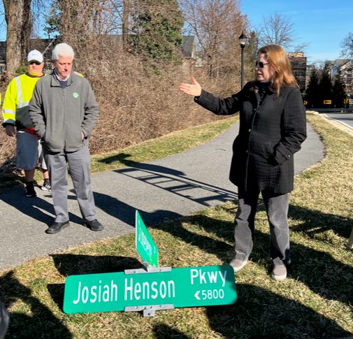 Montgomery County Planning Board Chair Casey Anderson (left) and Montgomery Planning Director Gwen Wright stand near the new Josiah Henson Parkway sign moments before it is installed.