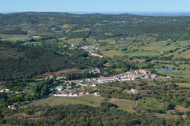 aerial view of the town of Portagem, Portugal showing concentrated growth and density surrounded by green farmlands.