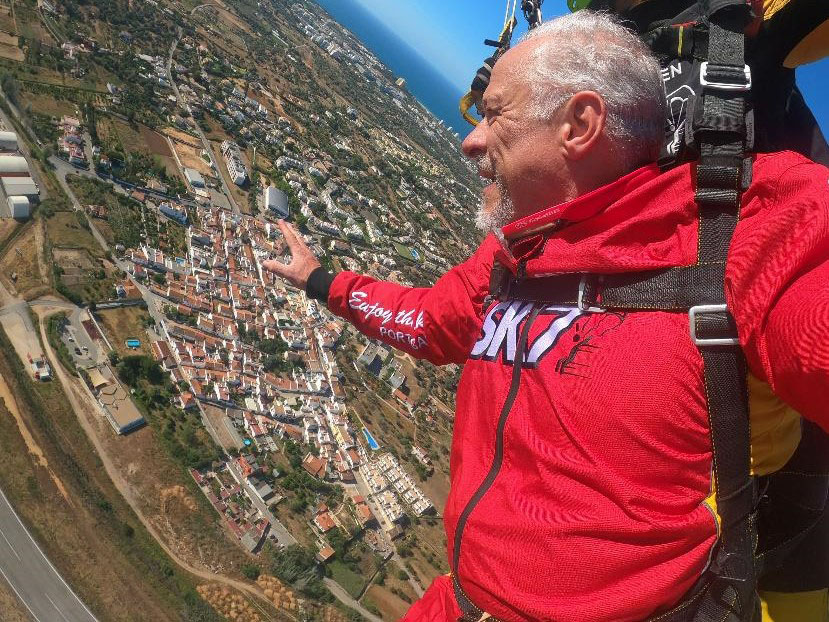 blog post author, Paul Mortensen” tandem sky diving above Largos, Portugal. He is pointing to Largos showing the dense town that makes up the “Complete Community” that is recommended in Thrive Montgomery 2050. 