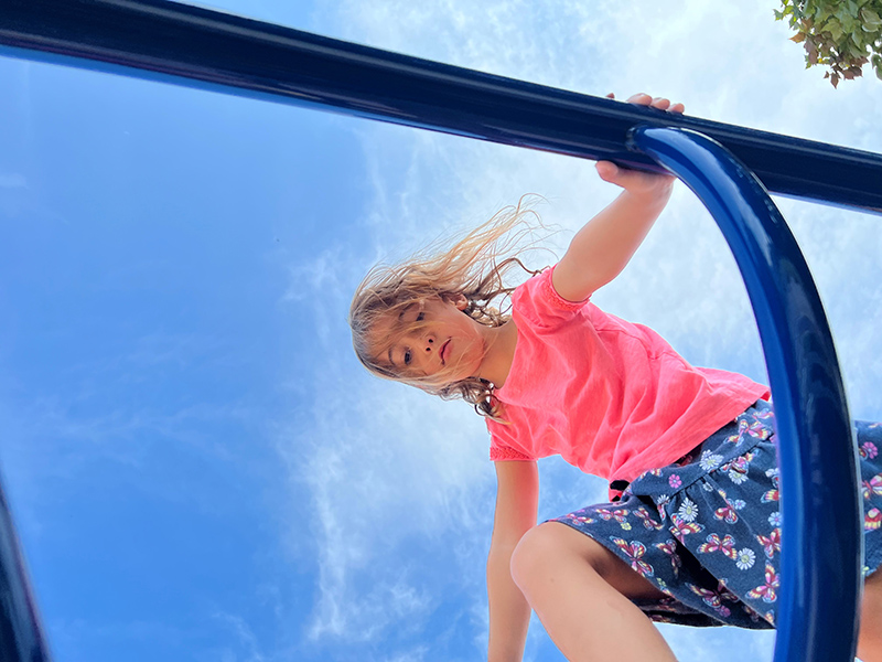 Girl on playground equipment