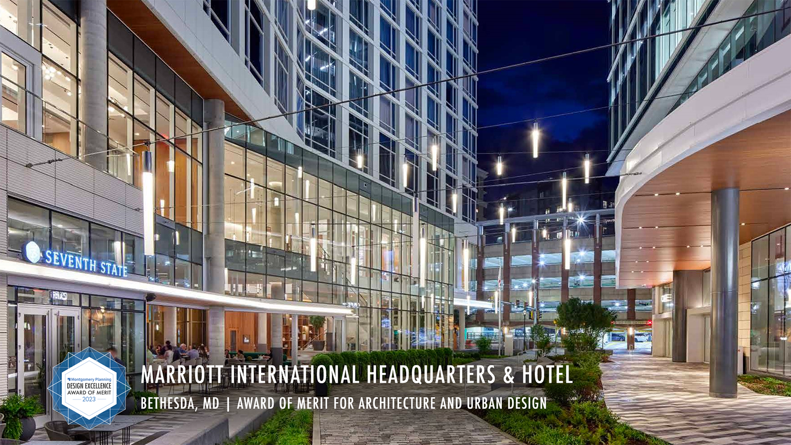 Modern outdoor plaza at Marriott International Headquarters & Hotel in Bethesda, MD, with string lights, glass buildings, outdoor seating, and the "Seventh Street" sign visible. Award label for architecture and urban design in the corner.