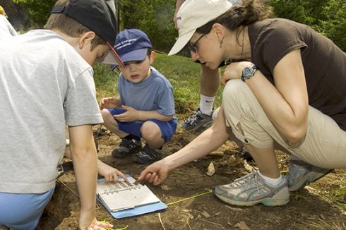 Parks visitors participate in an archeology activity.