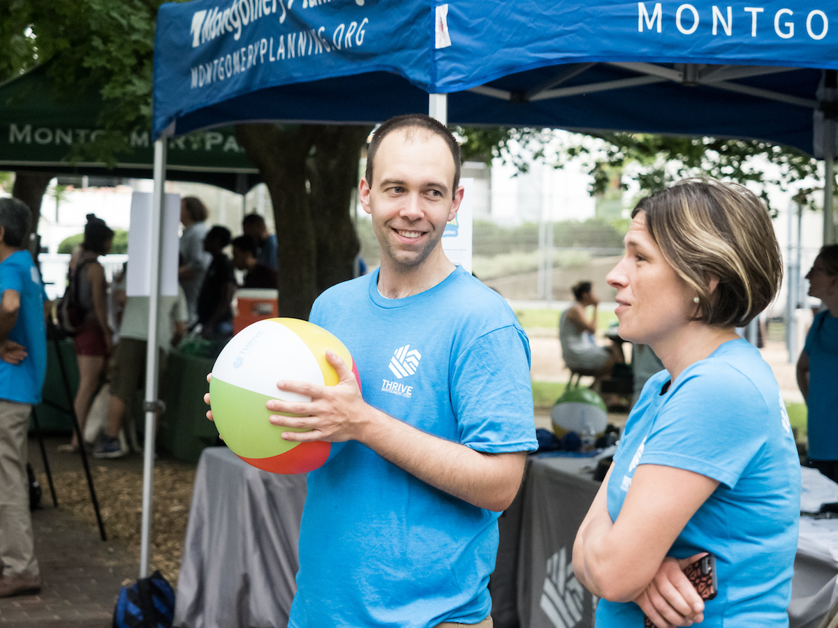 Montgomery Planning staff, one holding a beachball, at Yappy Hour