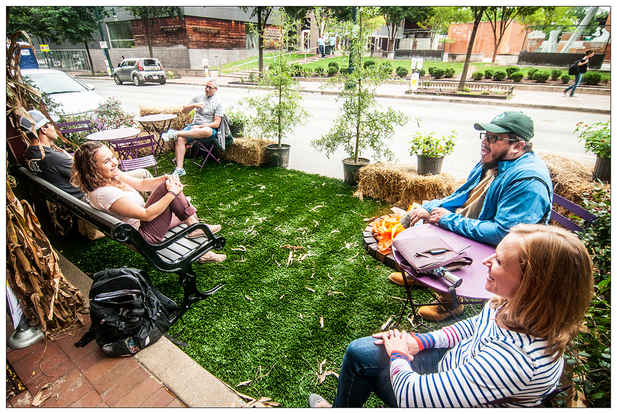 People enjoying a parklet in downtown Silver Spring during Park(ing) Day 2018