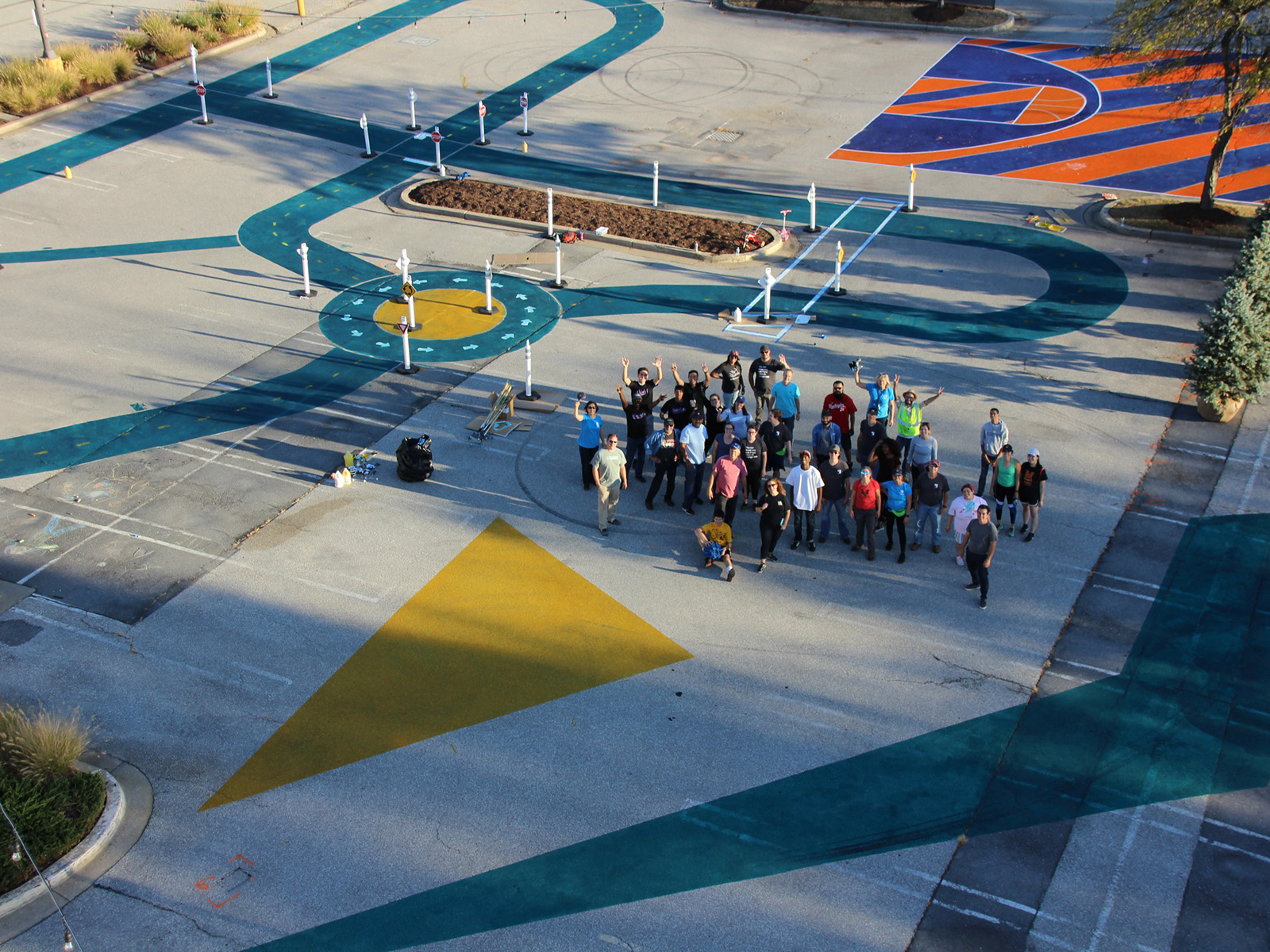 Aerial view of volunteers and painted parking lot