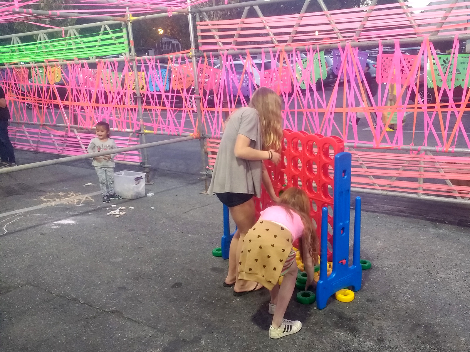 Woman and young girl play Connect Four in Friendship Lane