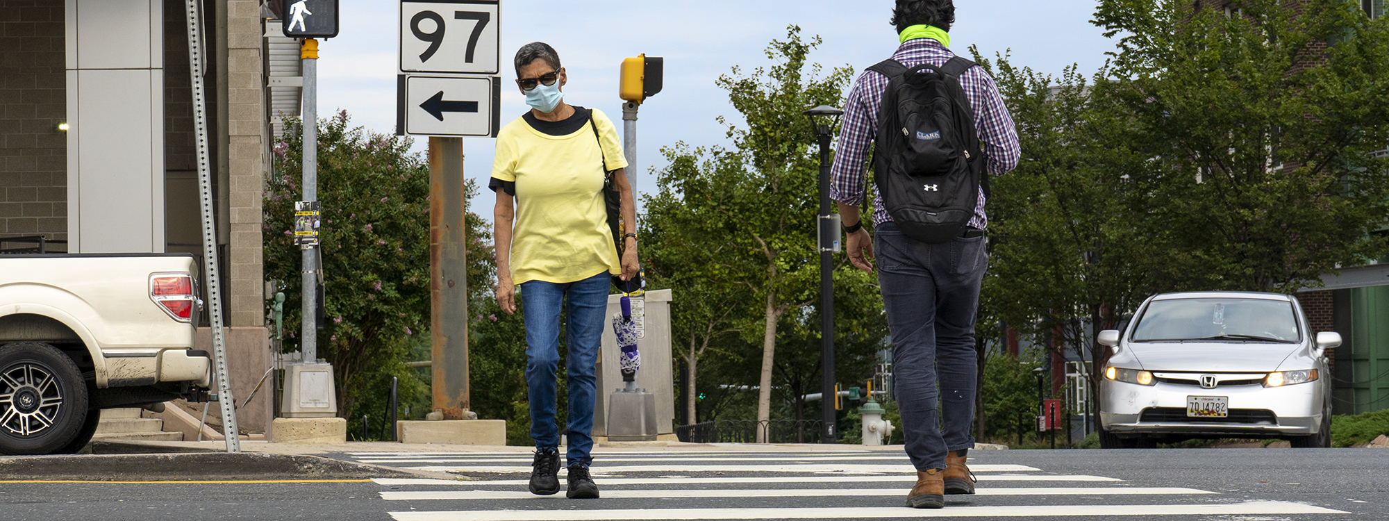 Pedestrian with face covering in crosswalk