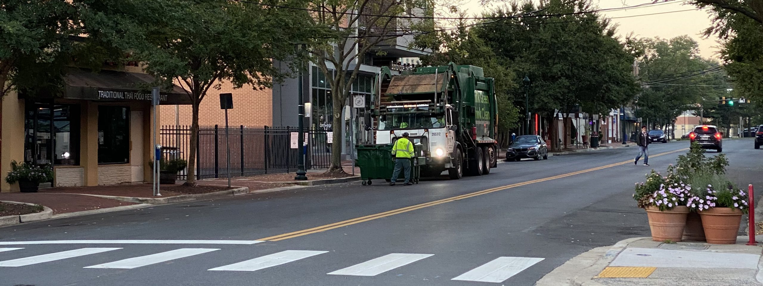 Garbage truck loading at curb