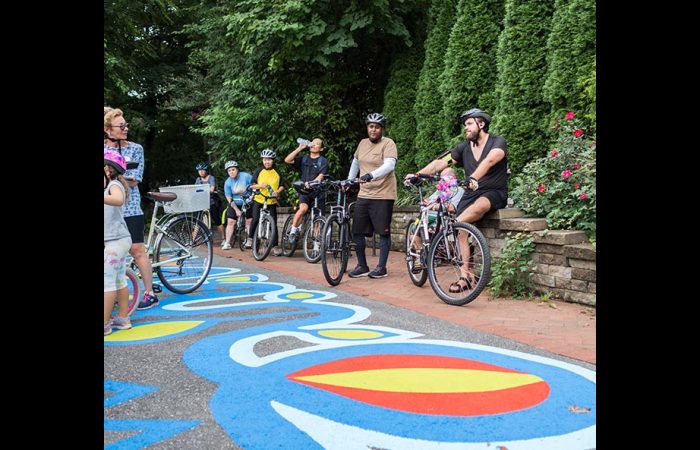 Pike District Connector launch event Cyclist by painted trail