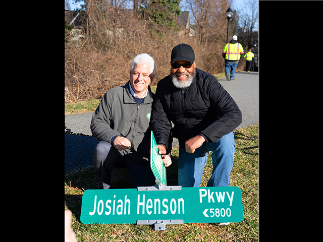 Planning Board Chair Casey Anderson and former Historic Preservation Commission Chair Warren Fleming by new Josian Henson Parkway sign