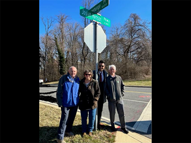 Planning Board members by stop sign with new Josiah Henson Parkway sign