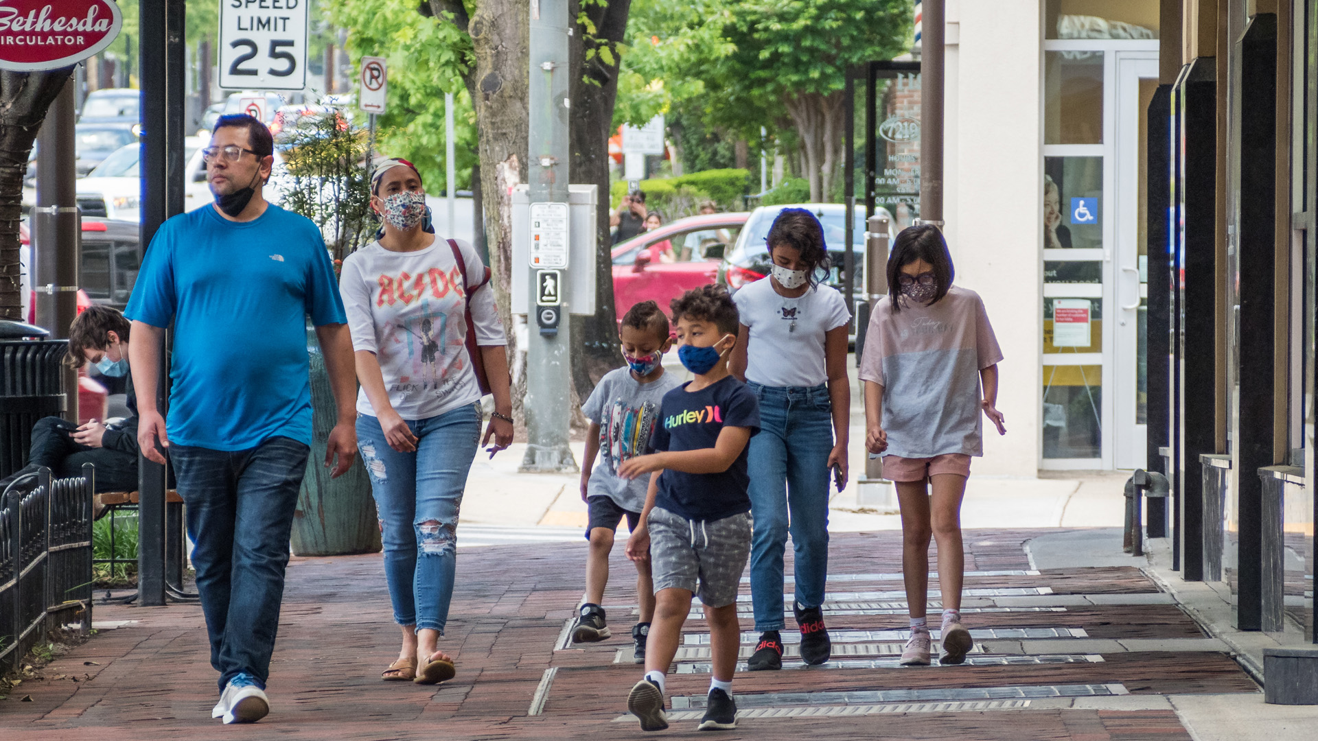 a family walking along a sidewalk in Bethesda