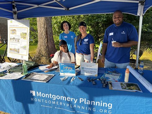 Montgomery Planning staff in blue shirts under blue tent