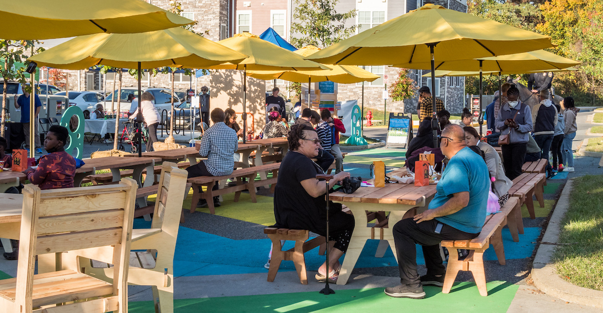 people sitting at outdoor tables