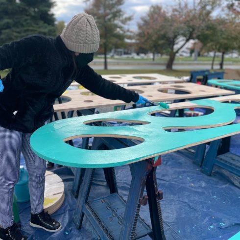 Volunteer paints component for Fairland and Briggs Chaney Placemaking Festival