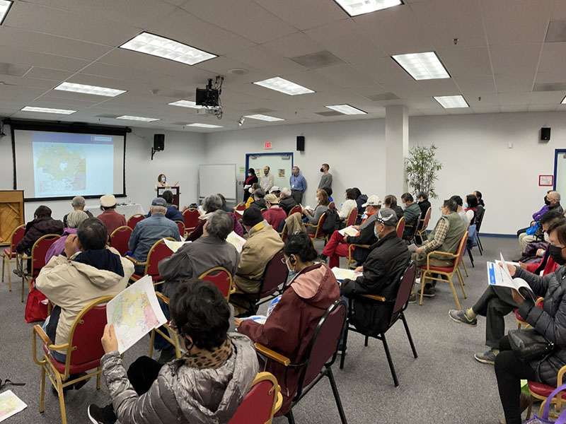 indoor gathering, audience watches presentation on screen at front of room