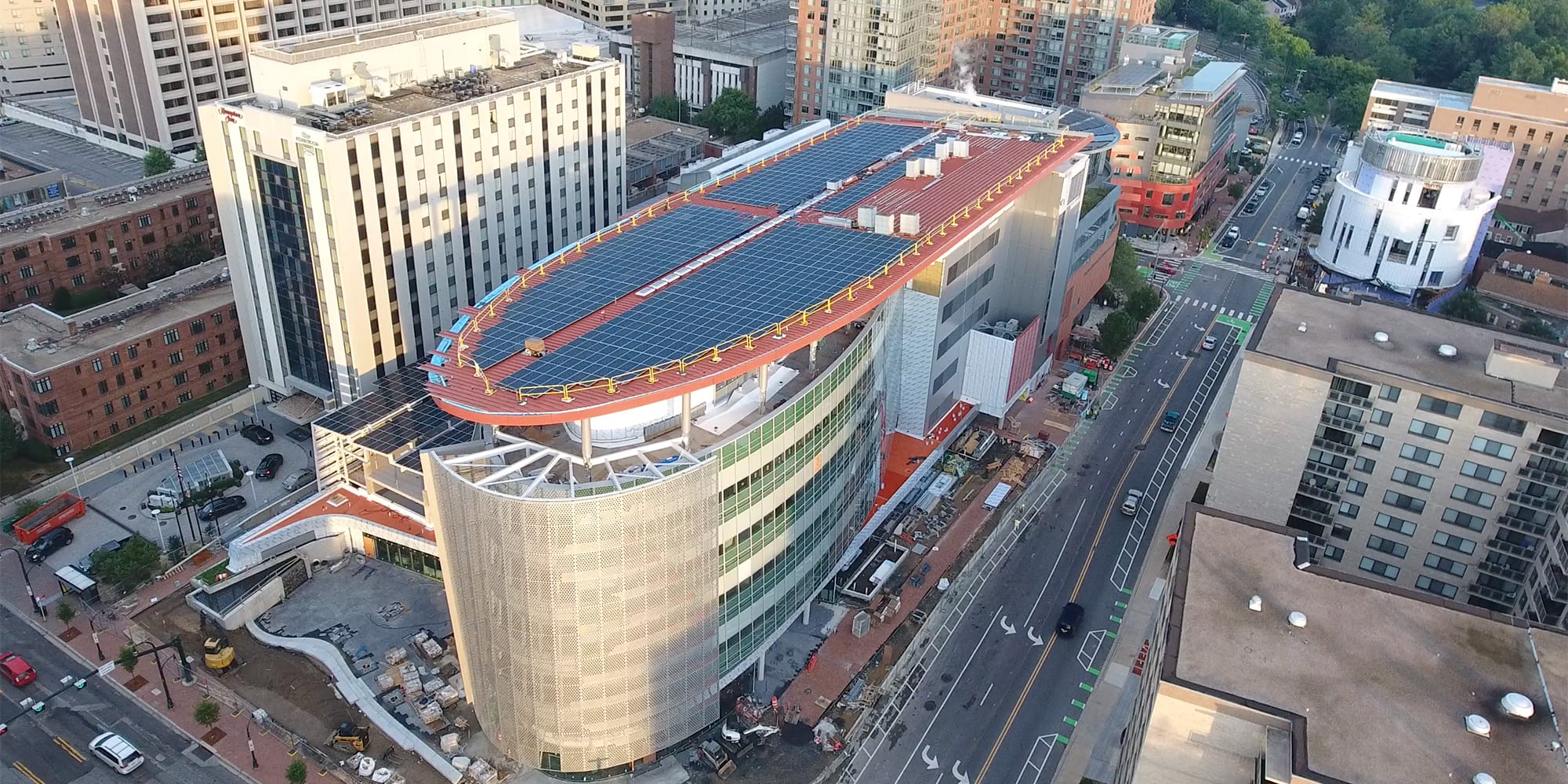 solar panels on high rise building roof in urban neighborhood