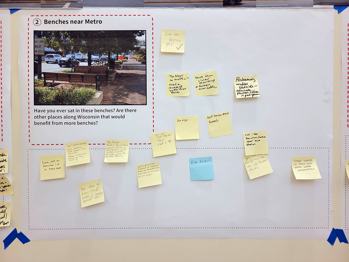 A bulletin board displays a printed photo of benches, a question about benches near the Metro, and numerous handwritten sticky notes with feedback.