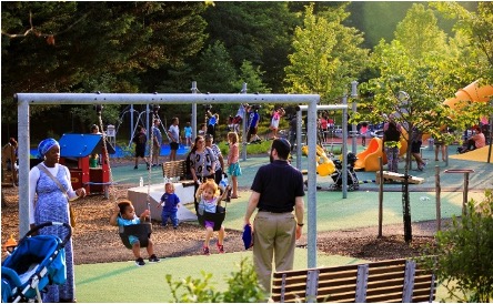 Kemp Mill Urban Park
Children and adults gather at a busy playground with swings, slides, and play structures on a sunny day.