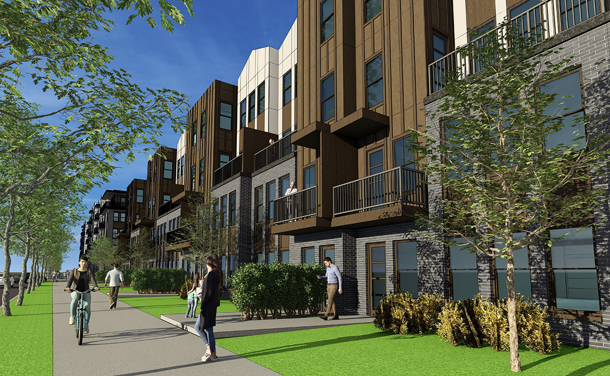 People walk and bike along a sidewalk next to a modern apartment building with balconies, landscaping, and trees under a clear blue sky.